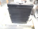 a black radiator sitting on a pallet in a garage