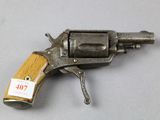 a close up of a gun on a table with a tag on it