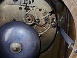 a close up of a clock with a blue ball inside of it