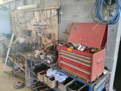 a red tool box sitting on a workbench in a garage