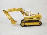 a toy excavator that is sitting on a white surface