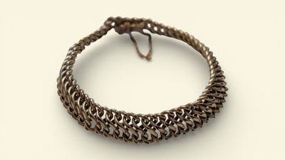 a close up of a bracelet on a white surface