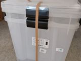 a large white box with a brown strap on it