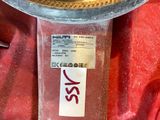 a close up of a clock on a red cloth