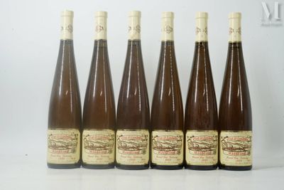 six bottles of wine are lined up in a row on a table
