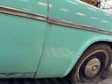 a blue car that is parked in a garage