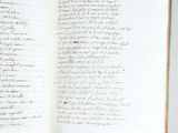 an open book with writing on it sitting on a table