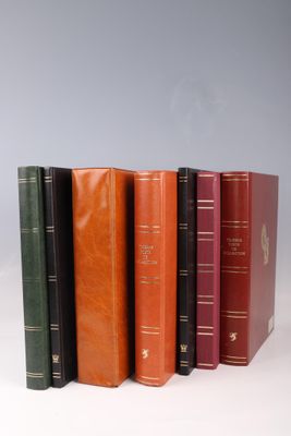 six different colored books lined up in a row on a white surface