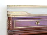 a wooden dresser with a marble top and gold trimmings