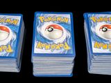 three packs of pokemon playing cards sitting on top of each other