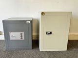 two safe boxes sitting next to each other on the floor