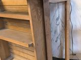 a wooden shelf that has a bunch of shelves on it