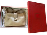 red box with a white purse inside of it on a white surface