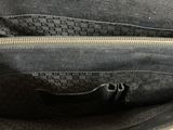 a close up of a black purse with a zipper
