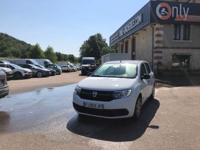 a white car parked in front of a building with cars parked in front of it