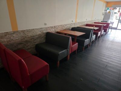 tables and chairs are lined up in a row in a restaurant