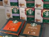 several boxes of starbucks coffee sit on a counter in a store