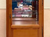 a wooden cabinet with a glass door on the side of it