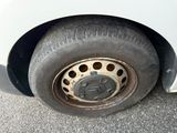 a white car with a flat tire on the street