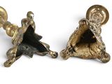 pair of antique brass candlesticks on a white background