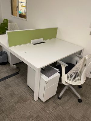 a desk with a chair and a computer on it