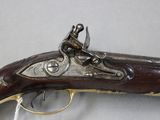 an old gun that is on display on a table