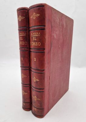 two red books sitting on top of each other on a white surface