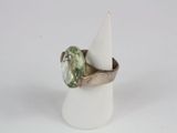 a ring with a green stone in it on top of a cone