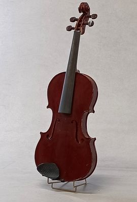a violin that is sitting on a stand on a white surface