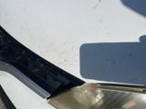 a close up of a car ' s headlight on a white car