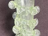 a glass vase that has a bunch of small flowers on it