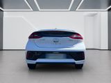 the rear end of a white car in a white room