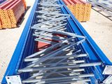 a person standing in front of a long metal structure