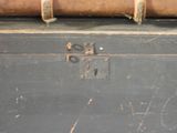 a piece of luggage sitting on top of a wooden trunk