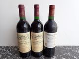 three bottles of wine sitting next to each other on a table