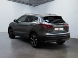 the rear end of a grey nissan qx - v parked in a garage