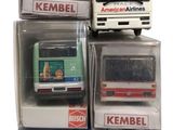 four different model buses in a box on a white background