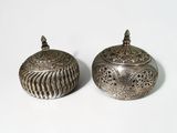 pair of antique silver plated sugar and butter pots on a white surface
