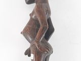 an old wooden statue of a man with a hat on his head