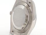 a silver watch that is sitting on a white surface