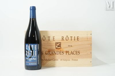 a bottle of wine sitting next to a wooden box