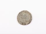 a close up of a coin on a white surface with a white background
