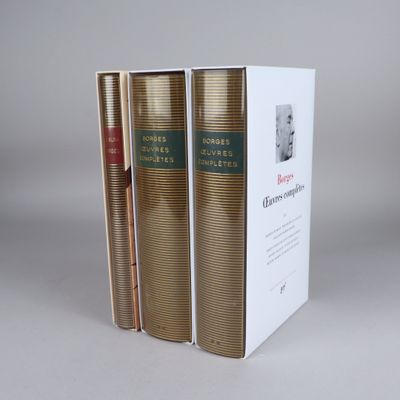 three books are stacked on top of each other on a table