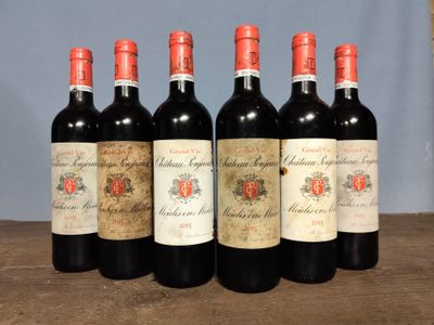 six bottles of red wine are lined up on a wooden table