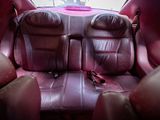 purple leather seats in a car with a pink seat belt