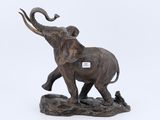 statue d'un éléphant posé sur un rocher, avec une étiquette sur le dos