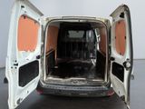 a white van with its doors open on a black floor