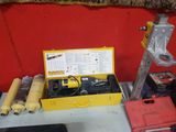 a yellow tool box sitting on a table next to a red wall