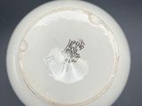 a white vase with a black and white design on it