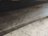 a close up of a black car with a hole in the side